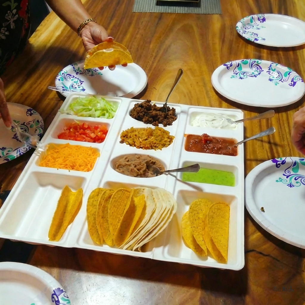 A full taco bar setup on a wooden table